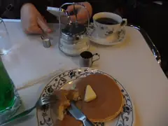 Note miniscule thimble of milk for coffee